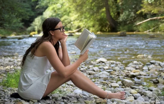 reading girl near river
